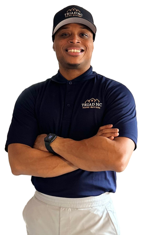 Confident male professional in a navy blue shirt with arms crossed in front of a white background.